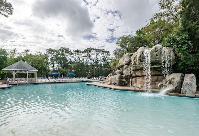 view of swimming pool featuring a gazebo and pool water feature