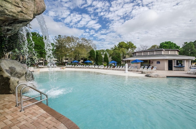 view of pool featuring pool water feature and a patio area