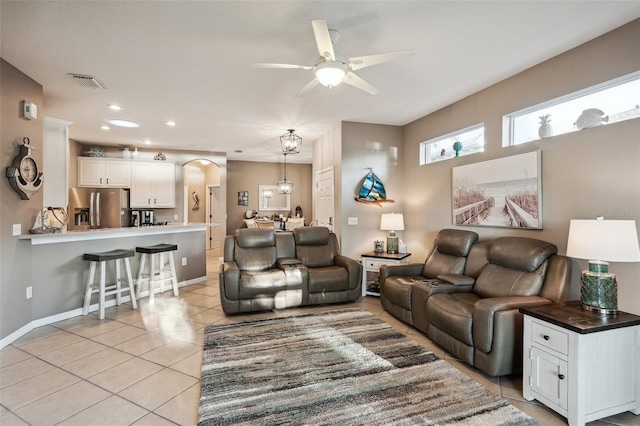 living room with ceiling fan and light tile patterned floors