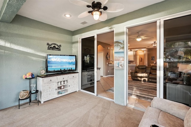 tiled living room featuring ceiling fan