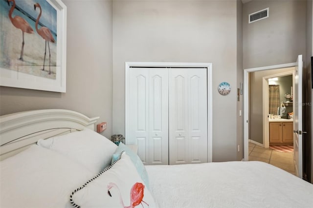 bedroom featuring sink, a closet, and light tile patterned floors