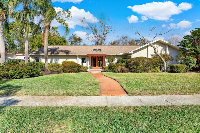 single story home featuring a front lawn