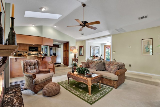 living room with lofted ceiling with skylight and ceiling fan