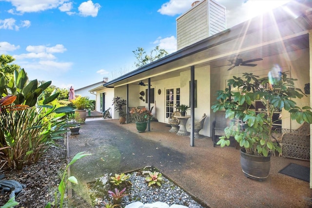 exterior space with ceiling fan