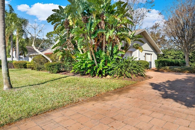 view of property exterior featuring a lawn