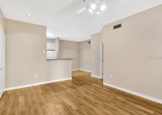 empty room featuring light hardwood / wood-style flooring and ceiling fan