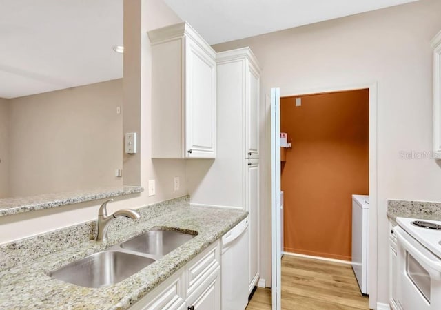 kitchen featuring light stone countertops, sink, white appliances, white cabinets, and light wood-type flooring