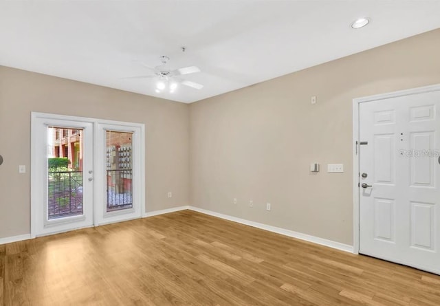 spare room featuring light hardwood / wood-style floors and ceiling fan