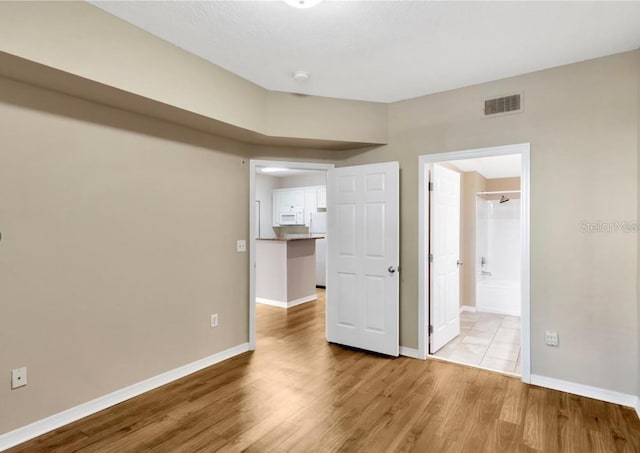 spare room with light wood-type flooring