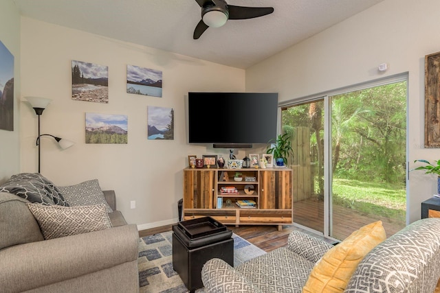 living room with lofted ceiling, ceiling fan, and wood-type flooring