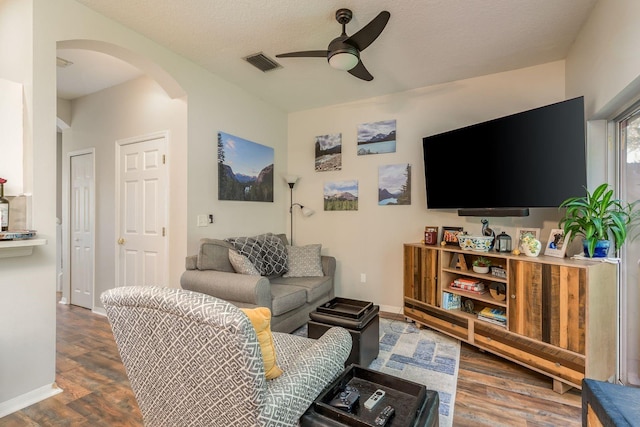 living room featuring a textured ceiling, ceiling fan, and hardwood / wood-style floors