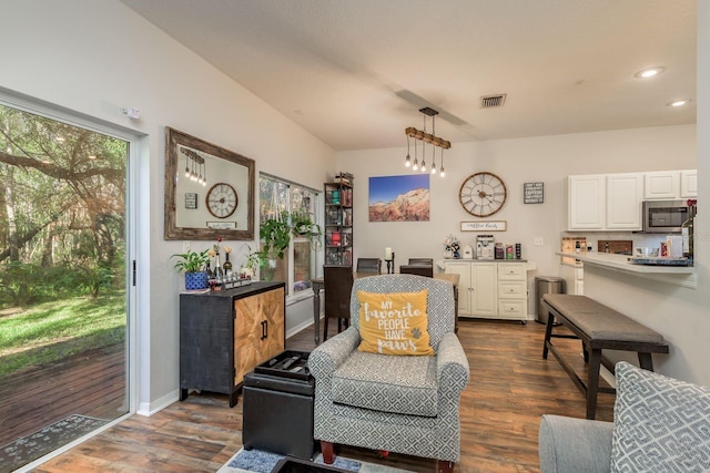 living area with a chandelier and dark hardwood / wood-style floors