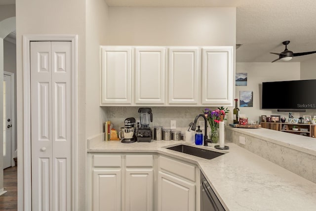 kitchen with sink, ceiling fan, white cabinets, and hardwood / wood-style floors