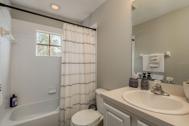 full bathroom with toilet, a textured ceiling, shower / tub combo, and vanity