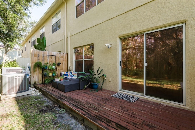 wooden deck featuring central AC unit and outdoor lounge area