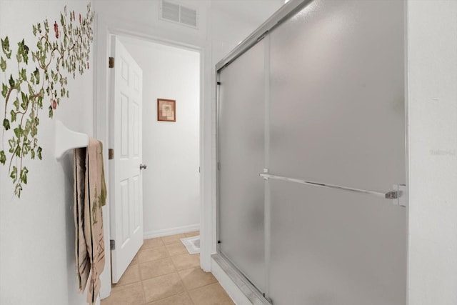 bathroom featuring an enclosed shower and tile patterned flooring