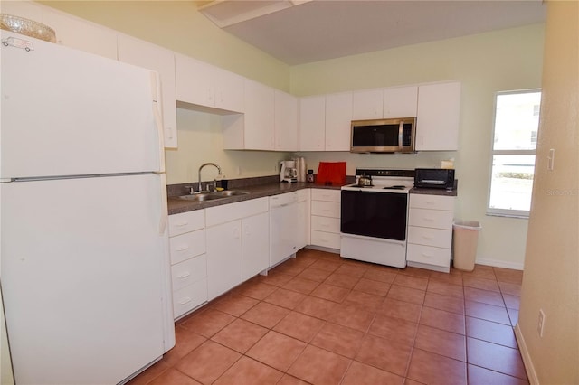 kitchen with sink, white appliances, white cabinetry, and light tile patterned floors