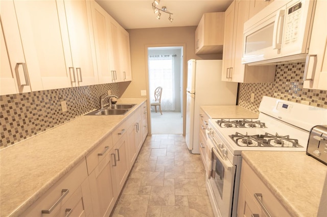 kitchen with white cabinets, white appliances, tasteful backsplash, and sink