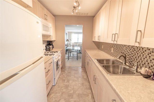 kitchen featuring white cabinets, white appliances, tasteful backsplash, and sink