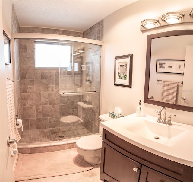 bathroom featuring tile patterned floors, vanity, toilet, and an enclosed shower