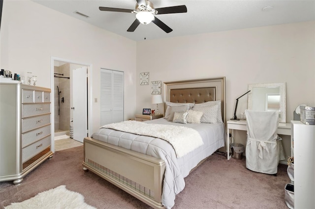 bedroom with carpet flooring, ensuite bathroom, ceiling fan, and a closet