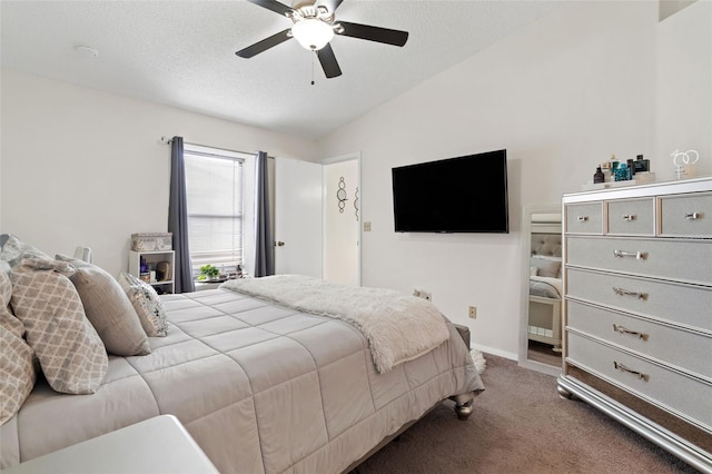 bedroom with ceiling fan, vaulted ceiling, a textured ceiling, and carpet flooring