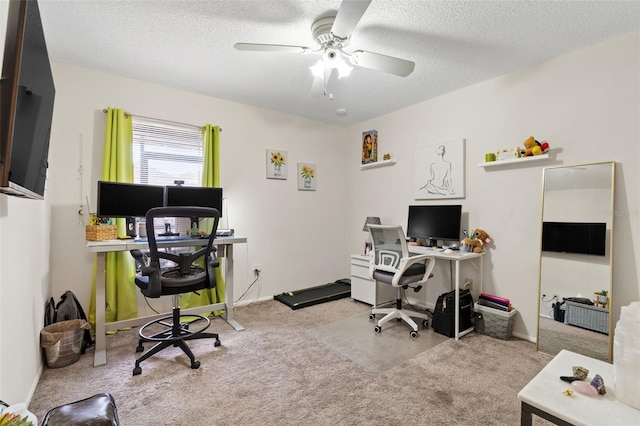 carpeted office with a textured ceiling and ceiling fan