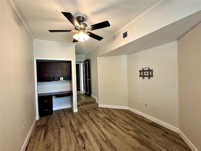 unfurnished bedroom with ceiling fan, hardwood / wood-style flooring, and ornamental molding