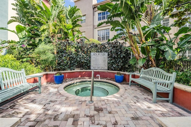 view of swimming pool featuring a patio area and a hot tub