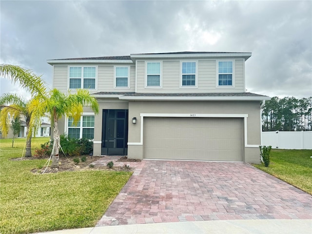 view of front of house featuring a front yard and a garage