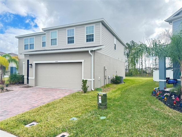 view of front of house with a garage and a front lawn