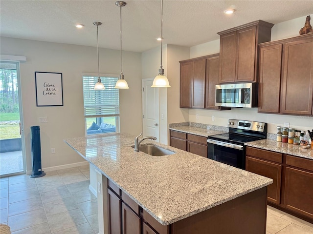 kitchen featuring a center island with sink, sink, and stainless steel appliances