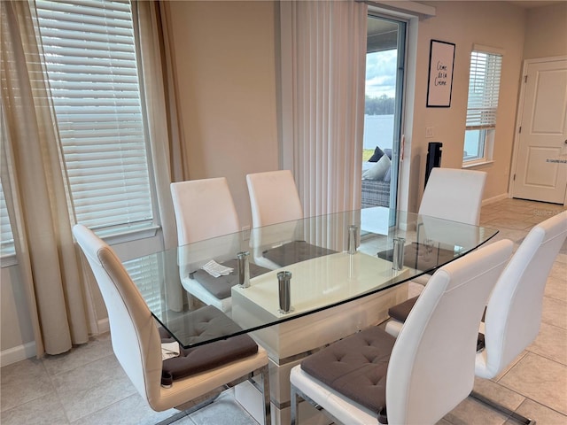 dining area featuring light tile patterned flooring