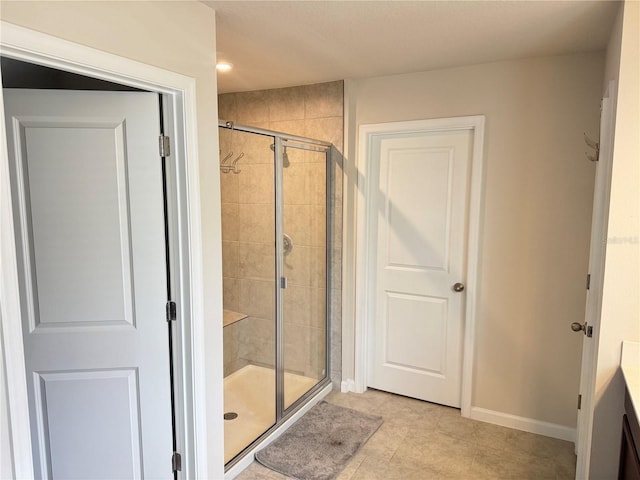 bathroom with tile patterned floors and a shower with door