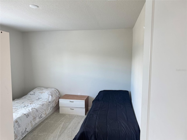 carpeted bedroom featuring a textured ceiling