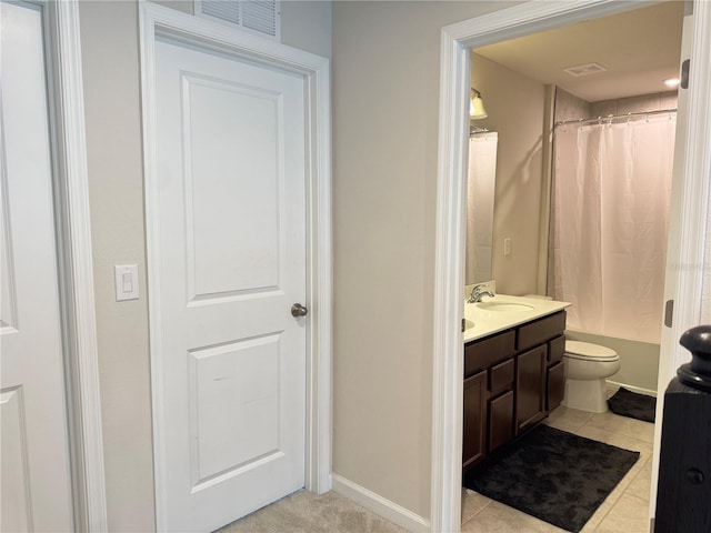 full bathroom featuring tile patterned flooring, vanity, toilet, and shower / tub combo