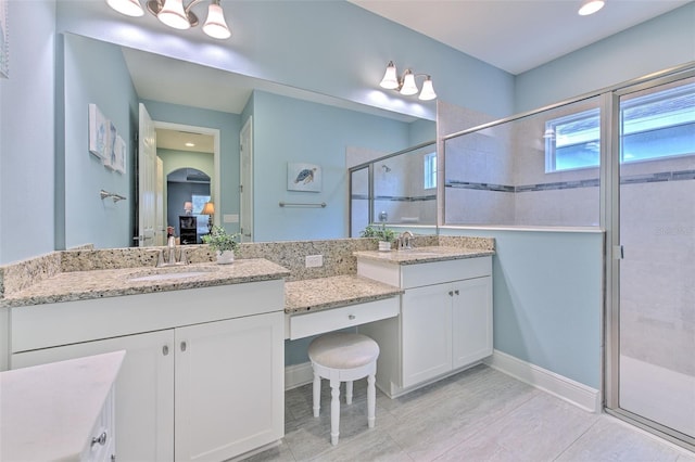 bathroom featuring vanity, tile patterned flooring, and an enclosed shower