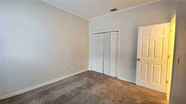 unfurnished bedroom featuring carpet and a closet