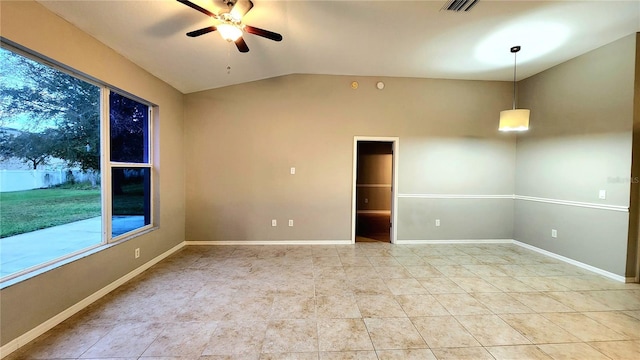 tiled spare room featuring ceiling fan and vaulted ceiling