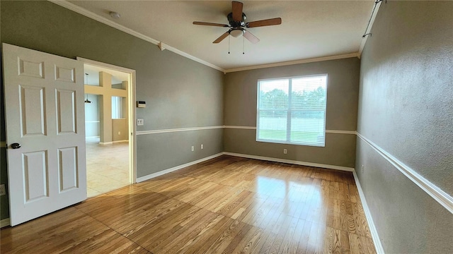 unfurnished room featuring ceiling fan, light hardwood / wood-style floors, and ornamental molding