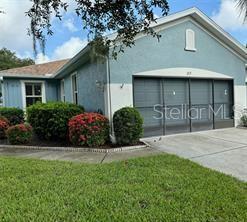 exterior space with a garage and a lawn