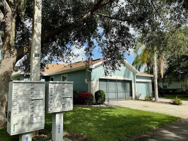 view of front of property featuring a front yard and a garage