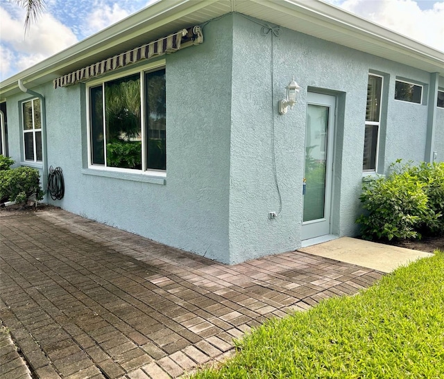 view of property exterior with a patio