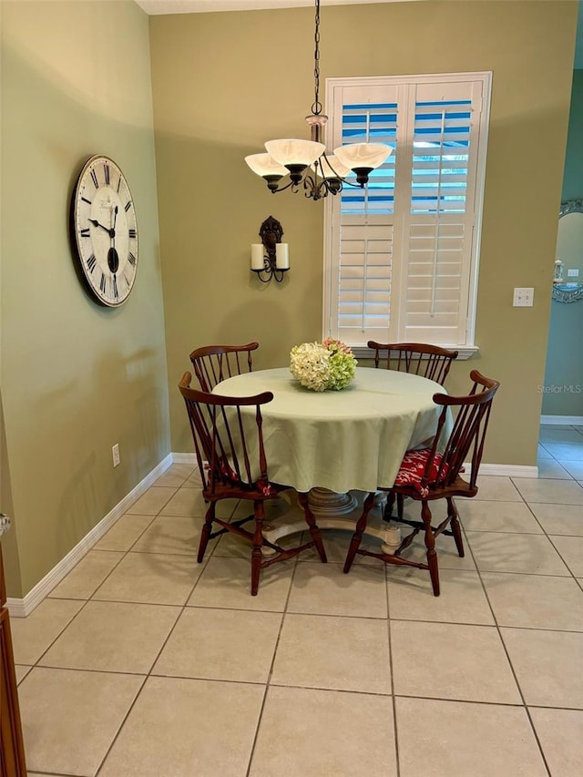 tiled dining space featuring a notable chandelier