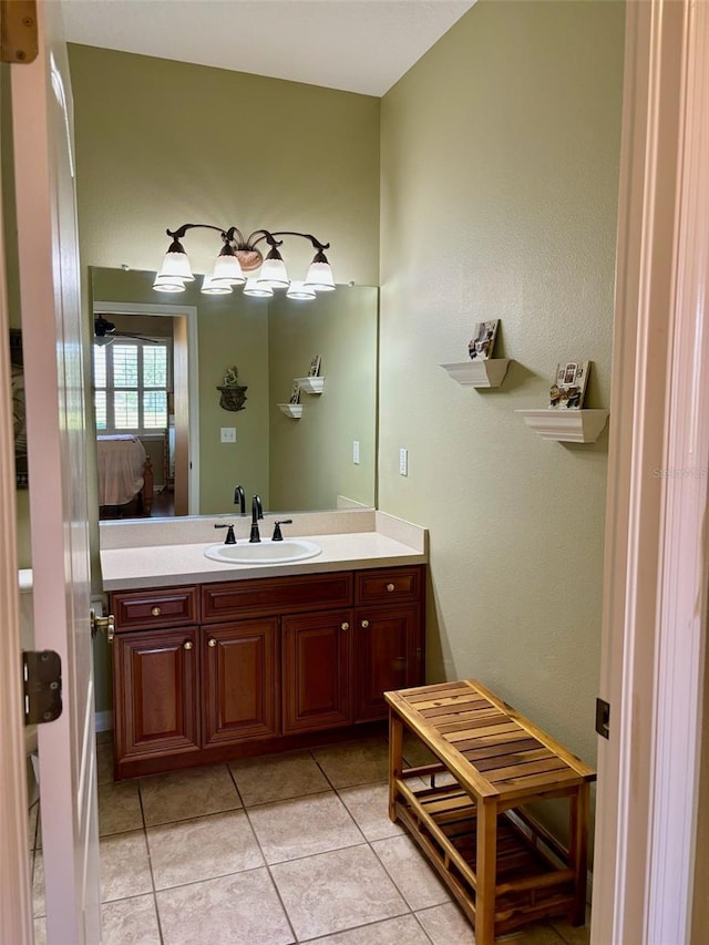 bathroom with ceiling fan, tile patterned flooring, and vanity