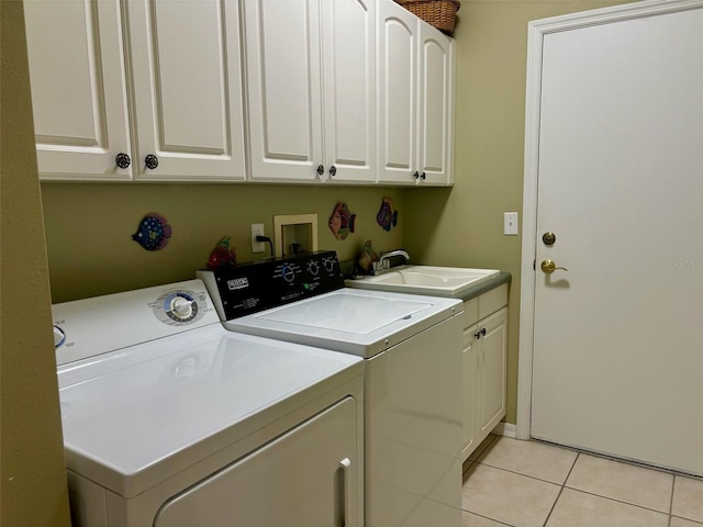 washroom with independent washer and dryer, cabinets, light tile patterned flooring, and sink