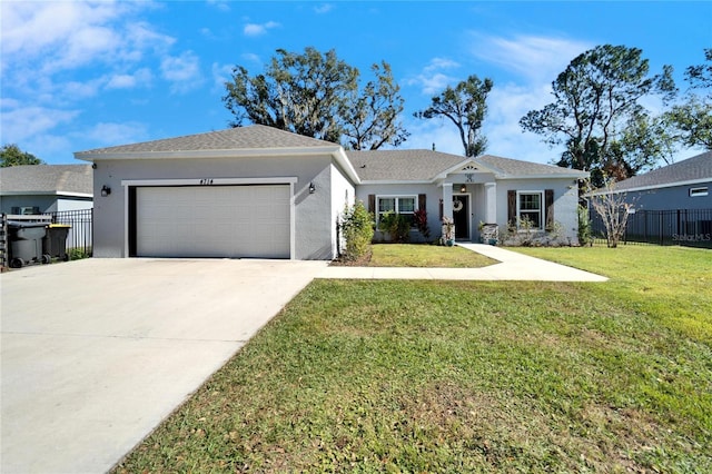 view of front of home with a front yard and a garage