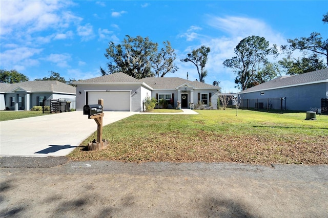 ranch-style home with a front yard and a garage