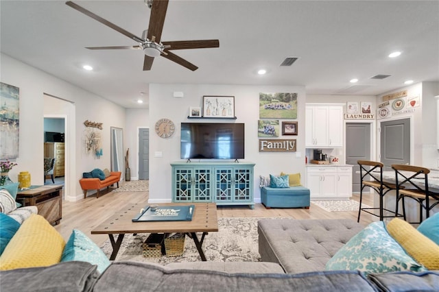 living room featuring ceiling fan and light wood-type flooring