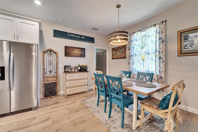 dining room featuring a chandelier and light hardwood / wood-style floors